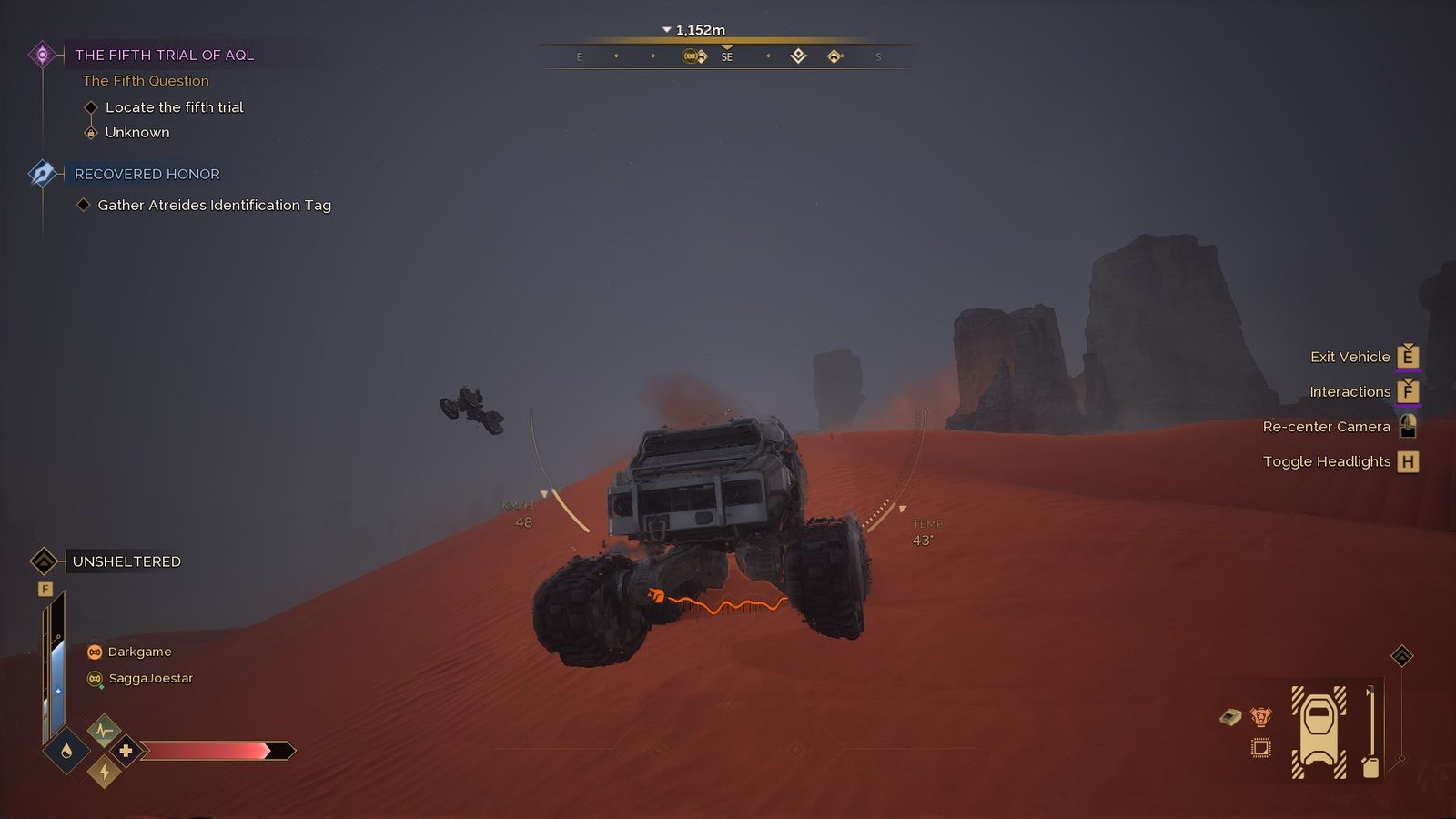 Vehicle driving on desert dunes with storm atmosphere and good scale.