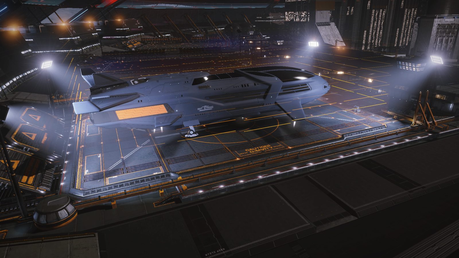 Ship docked in illuminated station hangar.