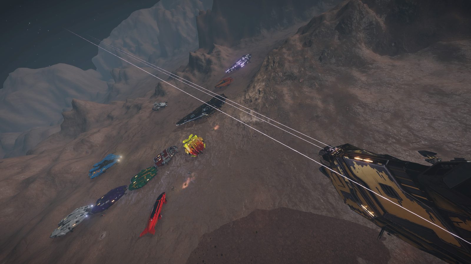 Overhead view of ships in formation with laser beams on rocky terrain.