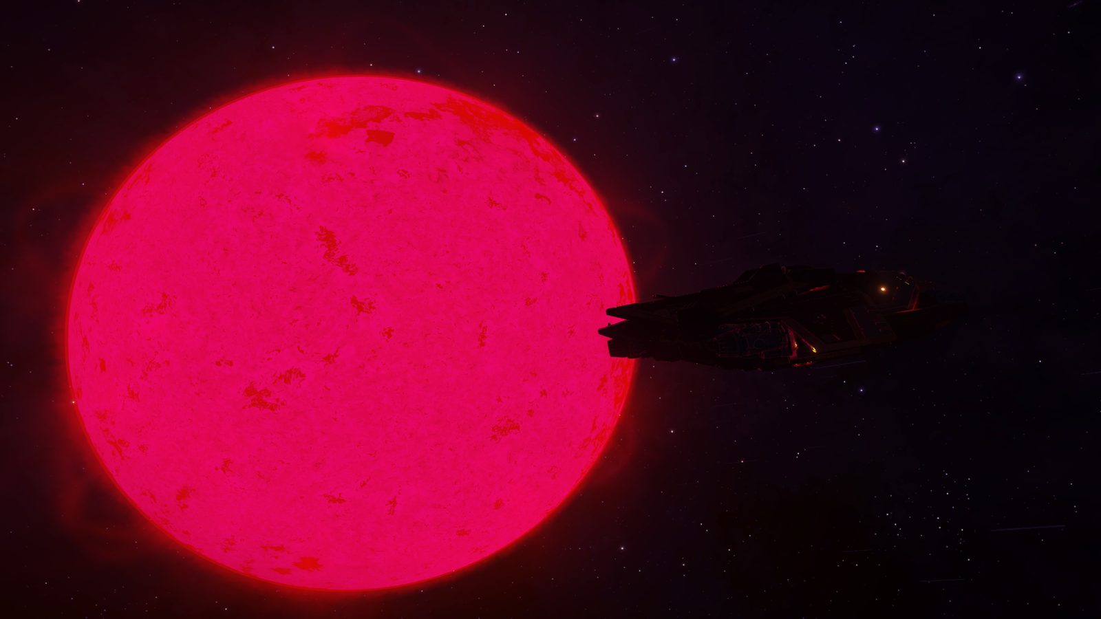 Ship silhouetted against a large bright red star.