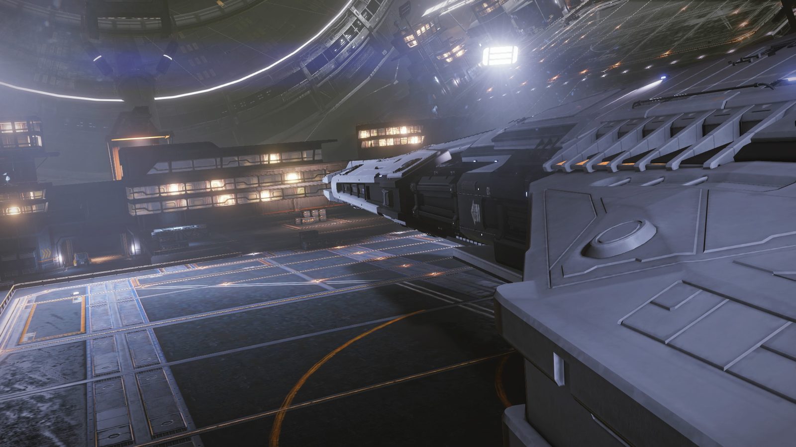 Ship docked in station hangar bay with ambient lighting.